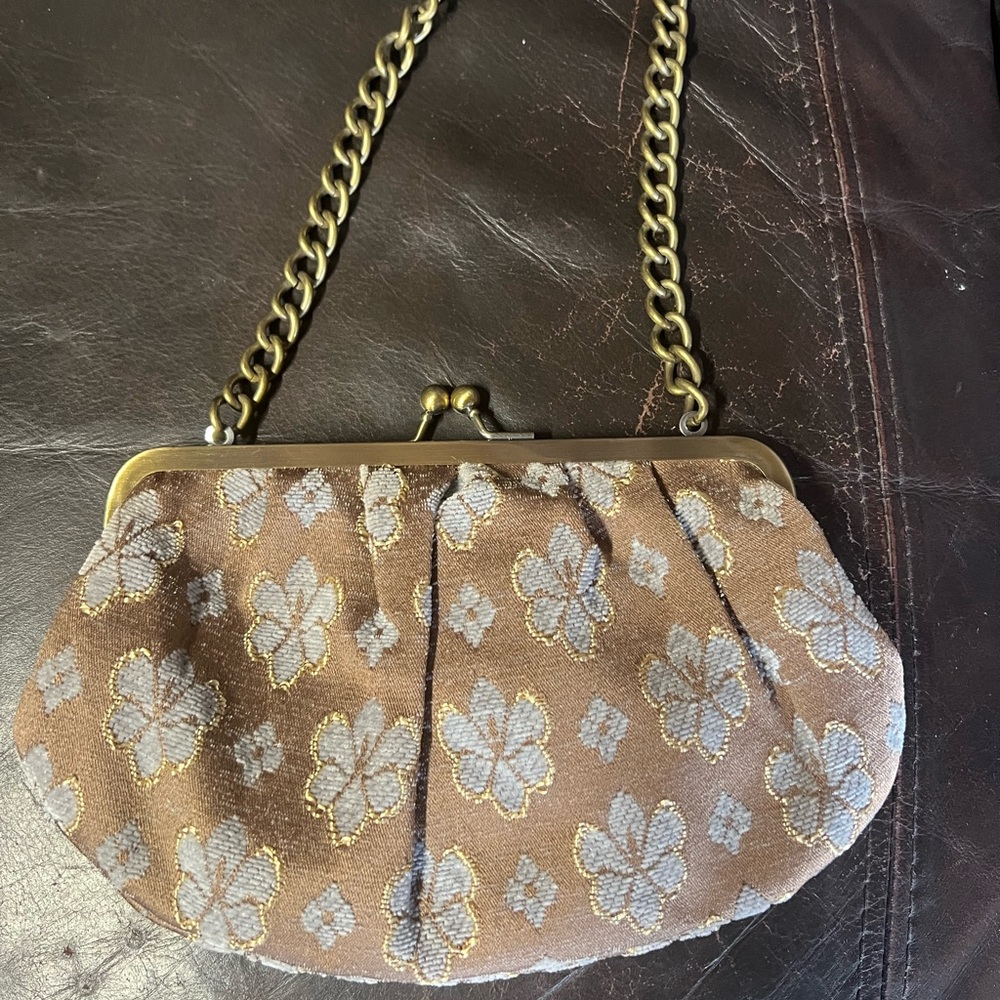 Fashion express small purse with satin/cloth floral print and chain for straps.